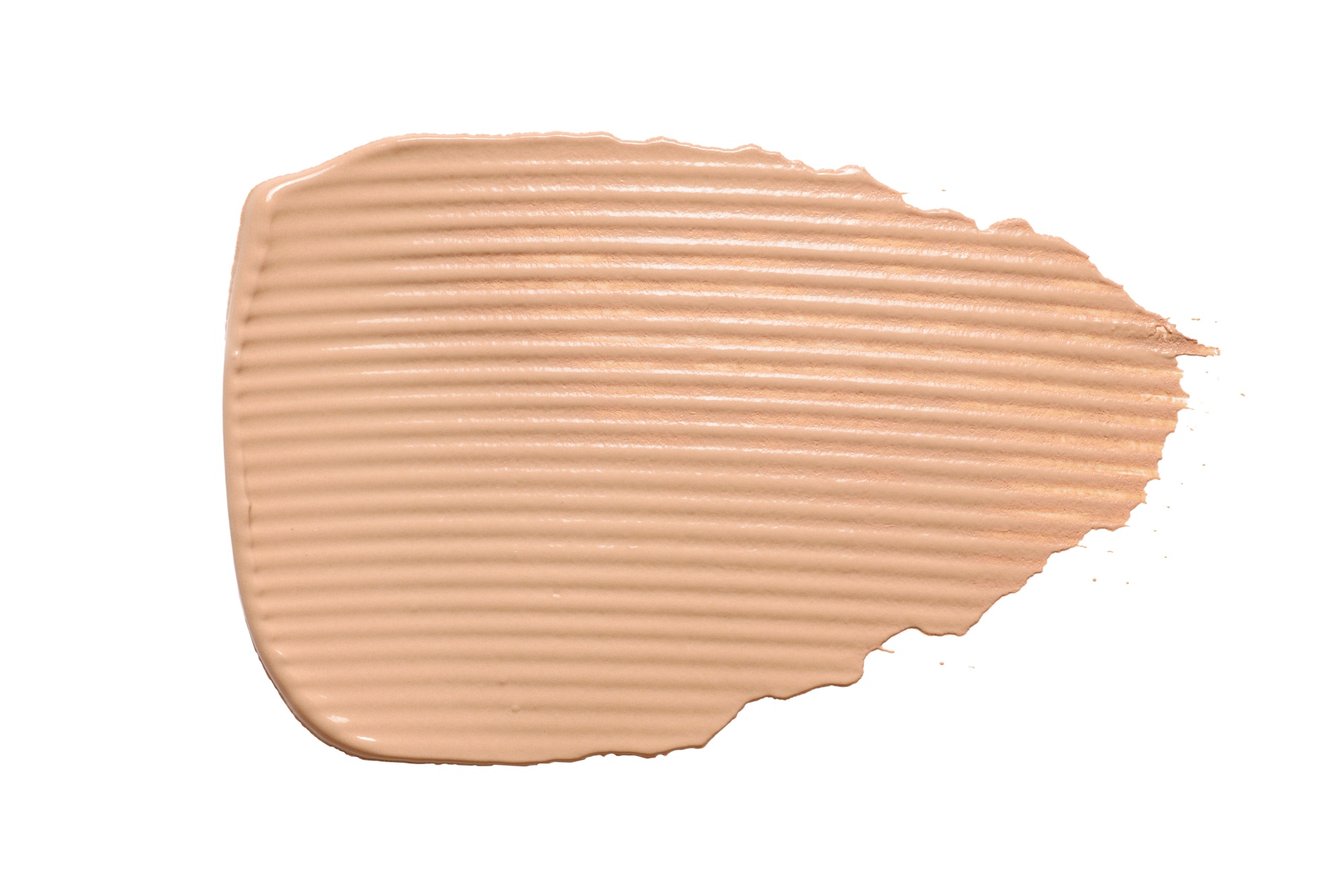 Beige skin tone CC cream smear isolated on white background.